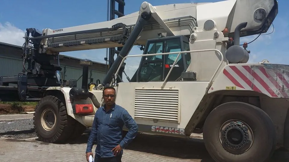 Engineer Kedir Ibrahim beside a Terex reach stacker at Modjo Dry Port during clearing of a trailer pump