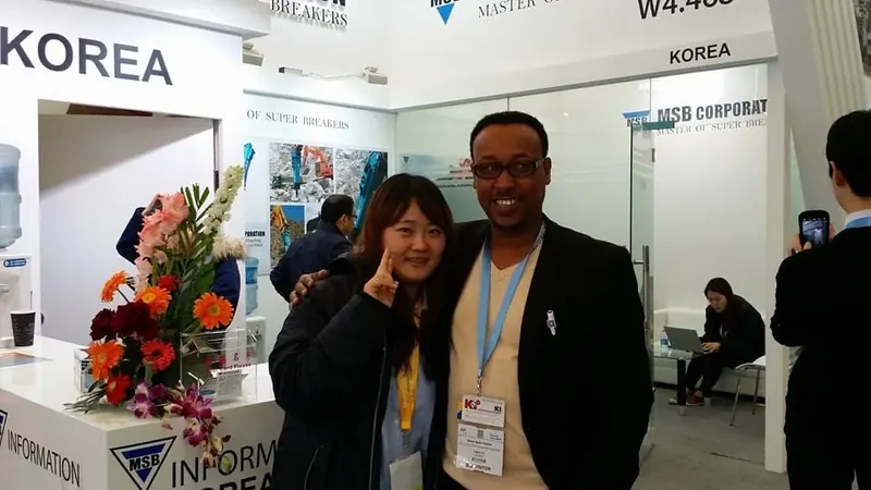 Engineer Kedir Ibrahim meeting an MSB hydraulic-breaker representative at a Korean exhibition