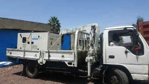 Perkins silent generator loaded on a crane truck for delivery to a customer