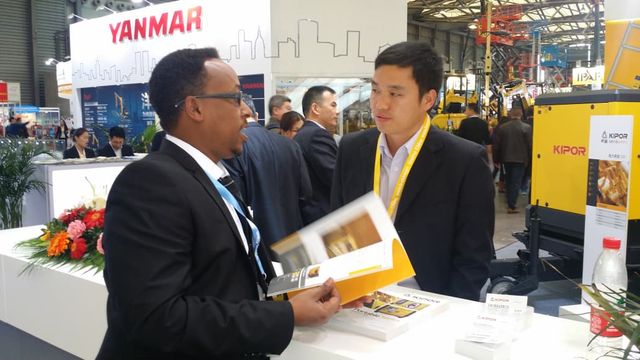 Mr. Kedir Ibrahim meeting a generating-set supplier at a KIPOR stand