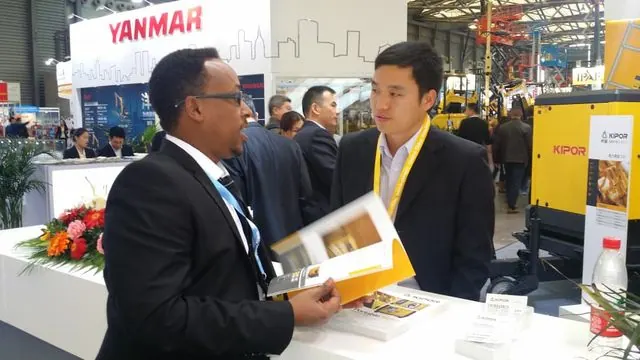 Engineer Kedir Ibrahim meeting a generating-set supplier at a KIPOR stand
